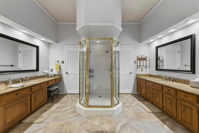 bathroom with vanity, ornamental molding, and an enclosed shower