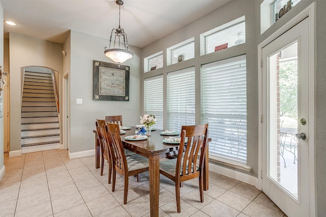 tiled dining space featuring a healthy amount of sunlight