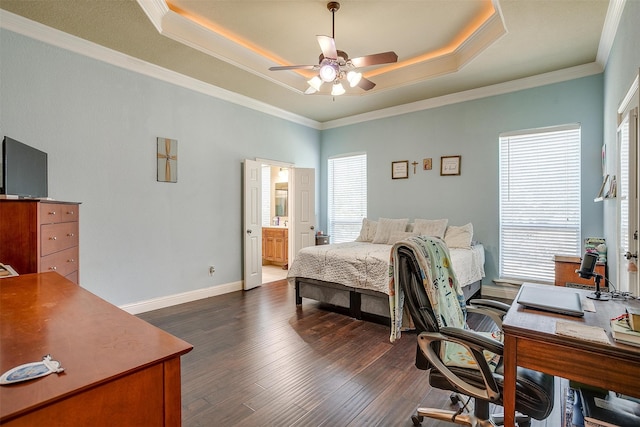 bedroom with crown molding, connected bathroom, ceiling fan, and dark wood-type flooring