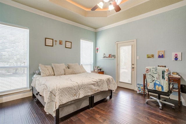 bedroom with ornamental molding, multiple windows, ceiling fan, and dark hardwood / wood-style floors