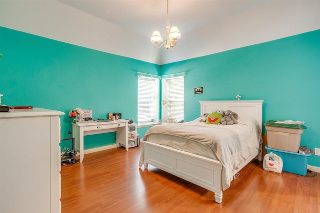 bedroom featuring a notable chandelier and hardwood / wood-style floors