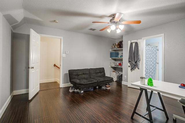 home office featuring ceiling fan, a textured ceiling, and dark wood-type flooring