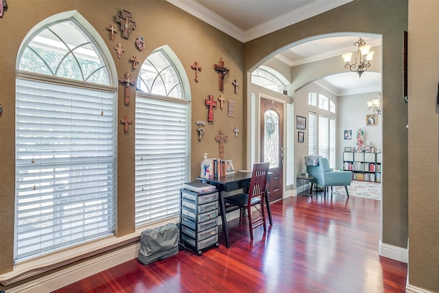 dining area featuring ornamental molding, hardwood / wood-style flooring, a chandelier, and a healthy amount of sunlight