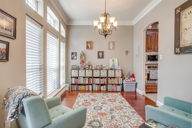 sitting room featuring ornamental molding, plenty of natural light, and dark hardwood / wood-style flooring