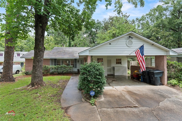 single story home featuring a front lawn and a carport