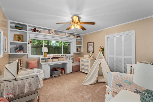 carpeted bedroom featuring crown molding, ceiling fan, and a closet