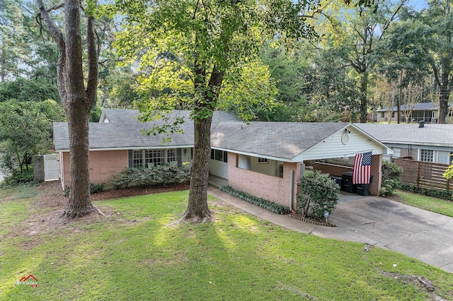 ranch-style home with a front lawn and a carport