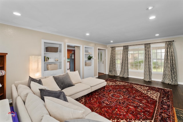 living room with ornamental molding, dark hardwood / wood-style floors, and built in features