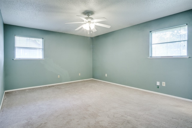 empty room with carpet floors, a textured ceiling, and ceiling fan