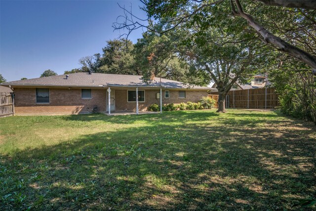 rear view of house with a yard