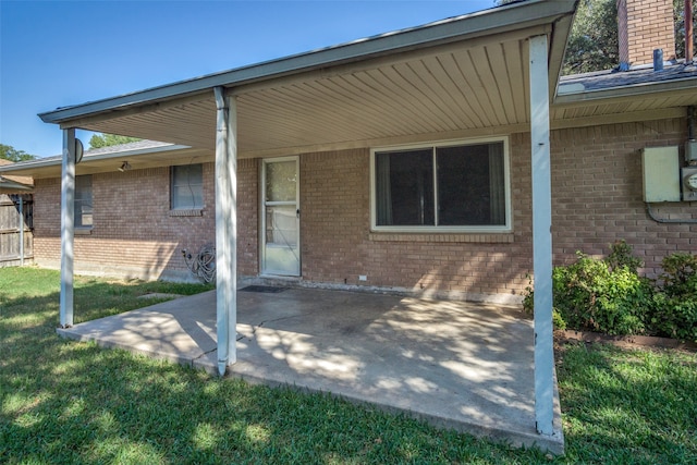 rear view of house with a patio and a yard