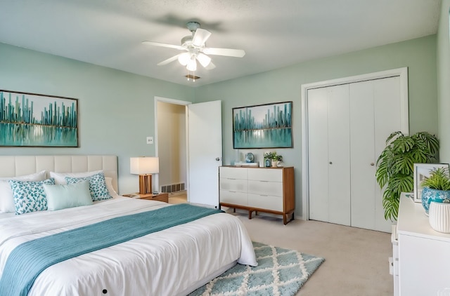 carpeted bedroom with a closet and ceiling fan