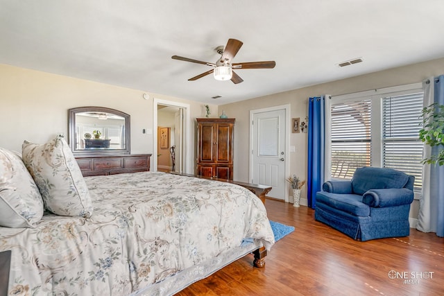 bedroom with ceiling fan and hardwood / wood-style flooring