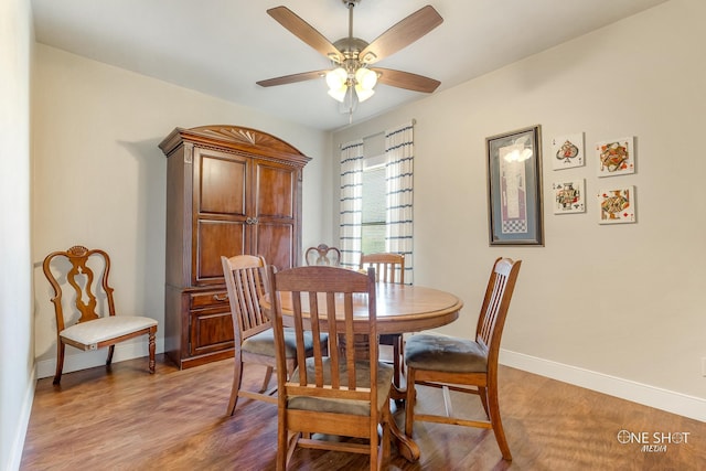 dining space with wood-type flooring and ceiling fan