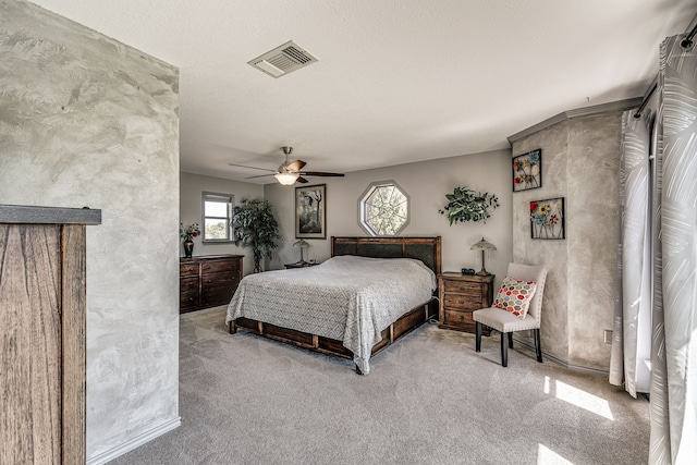 bedroom with ceiling fan, a textured ceiling, and carpet