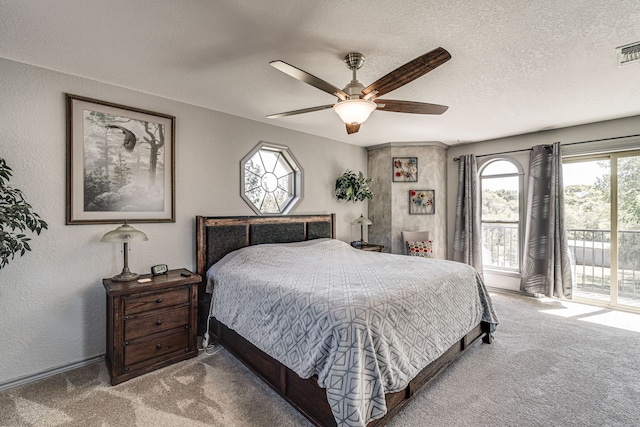 bedroom with a textured ceiling, carpet, ceiling fan, and access to exterior