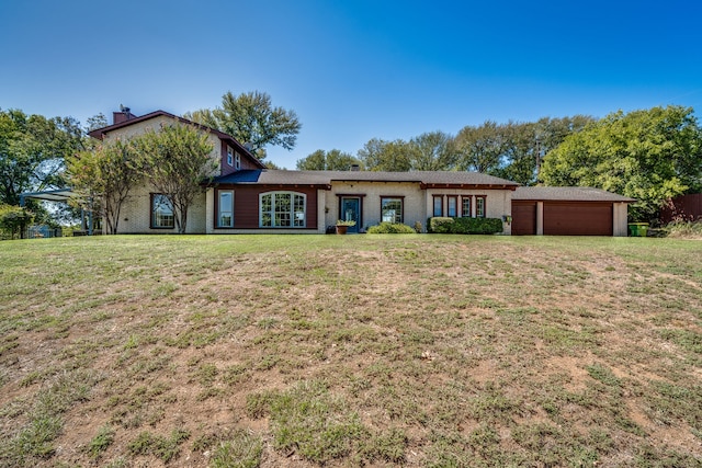 ranch-style home featuring a garage and a front lawn