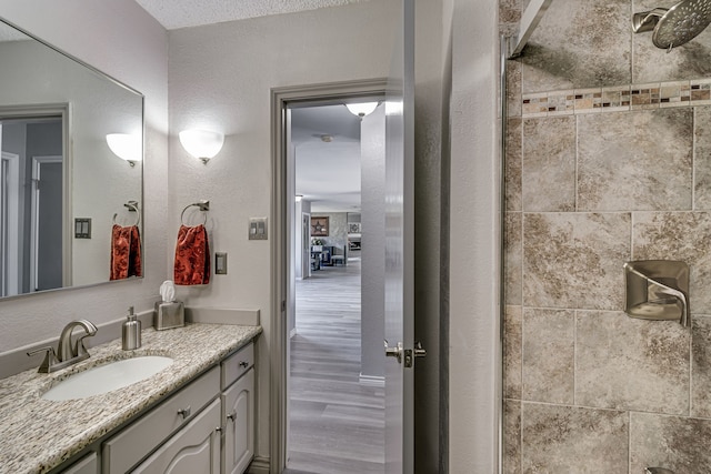 bathroom with vanity, hardwood / wood-style floors, and a textured ceiling