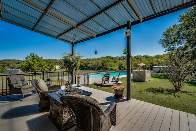 wooden deck with a yard and a fenced in pool