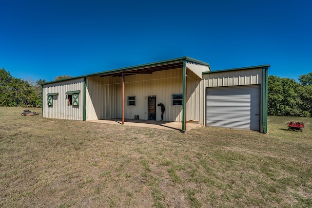 view of outbuilding with a lawn and a garage