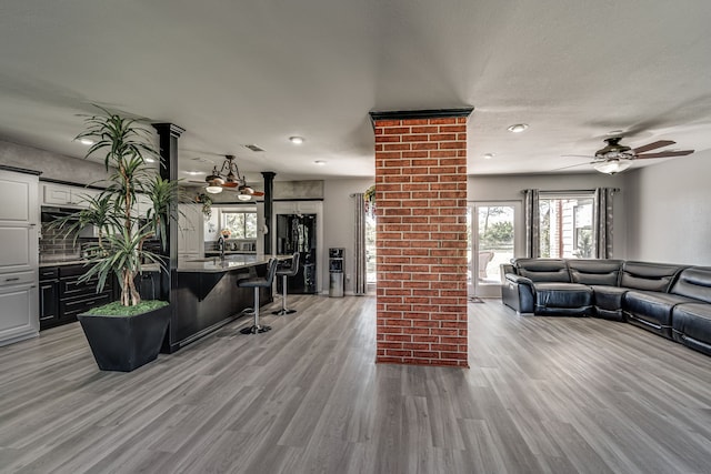 living room featuring light wood-type flooring and ceiling fan