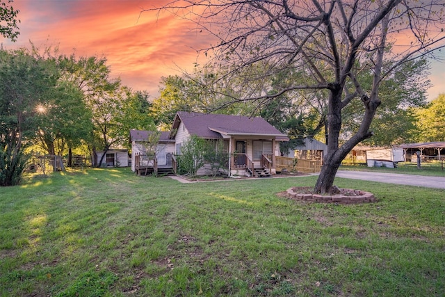 view of front of home featuring a lawn and covered porch