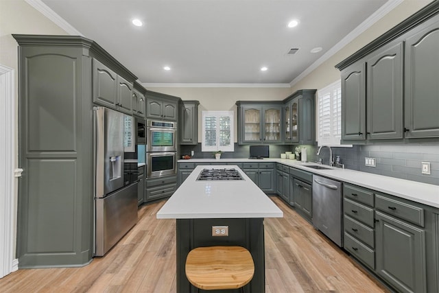 kitchen featuring light hardwood / wood-style floors, sink, stainless steel appliances, and a center island