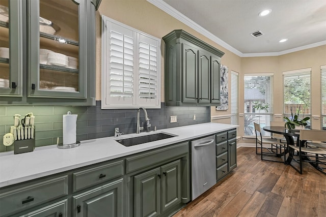 kitchen featuring sink, dark hardwood / wood-style flooring, stainless steel dishwasher, backsplash, and crown molding