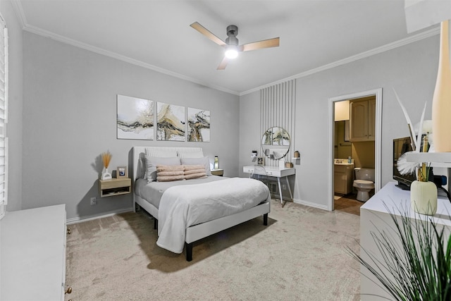 bedroom featuring carpet flooring, ensuite bath, ceiling fan, and crown molding