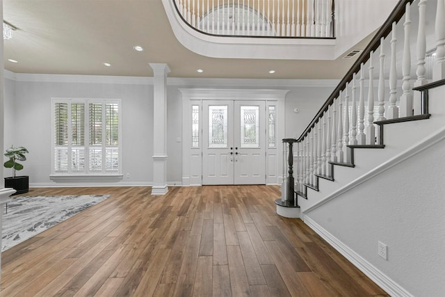 sitting room featuring hardwood / wood-style flooring, crown molding, and an inviting chandelier