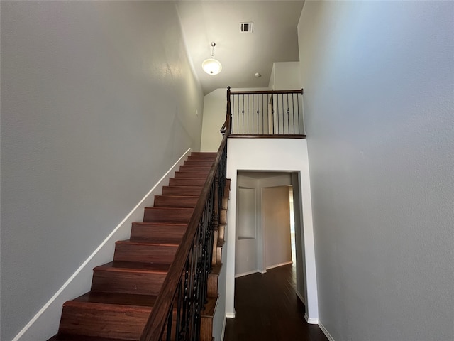 stairway with hardwood / wood-style floors