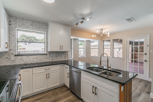 kitchen with white cabinets, dishwasher, kitchen peninsula, and a healthy amount of sunlight