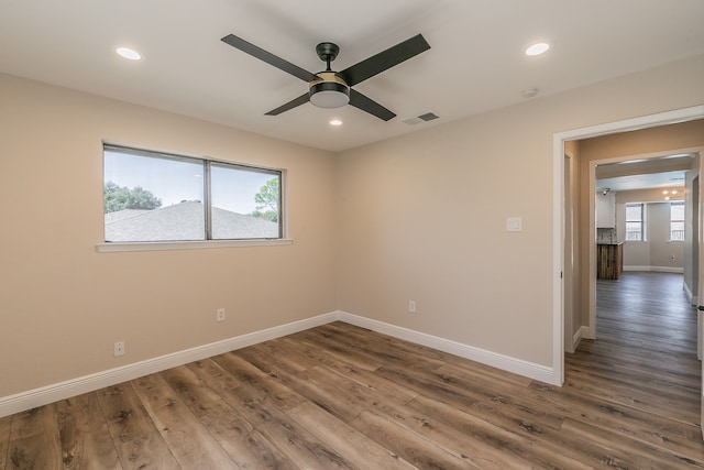 empty room with ceiling fan and dark hardwood / wood-style floors