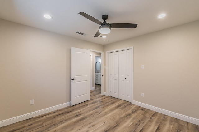 unfurnished bedroom featuring a closet, ceiling fan, and light wood-type flooring