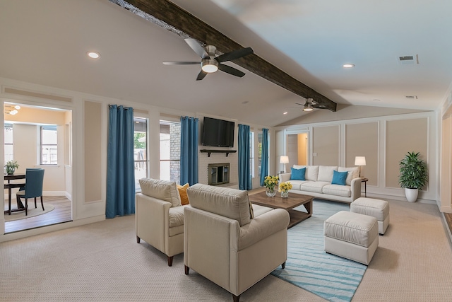 living room with ceiling fan, vaulted ceiling with beams, and light colored carpet