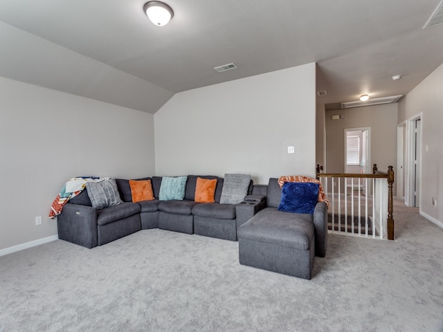 carpeted living room featuring lofted ceiling