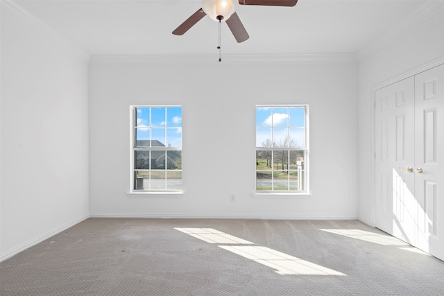 spare room featuring light colored carpet and a wealth of natural light