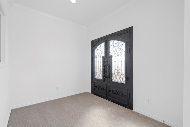 carpeted foyer entrance with french doors and crown molding