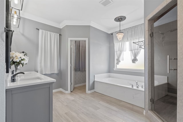 bathroom with an inviting chandelier, wood-type flooring, vanity, independent shower and bath, and ornamental molding