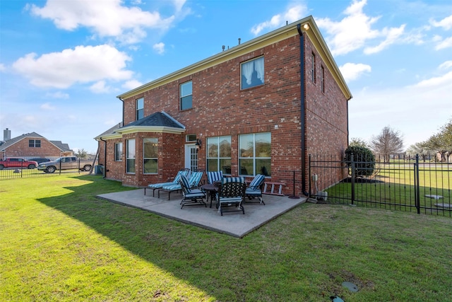 rear view of house featuring a lawn and a patio area