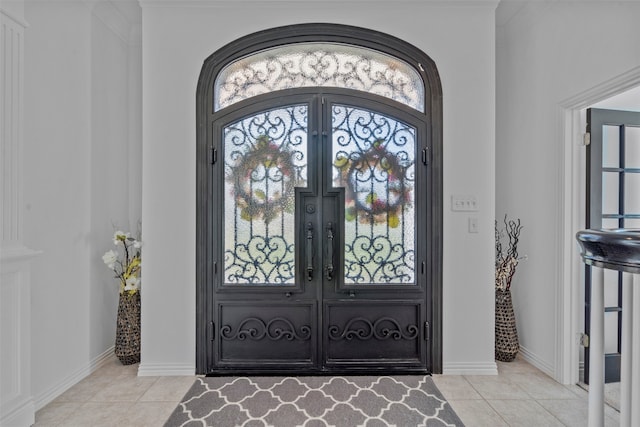 foyer entrance featuring a wealth of natural light, french doors, and light tile patterned flooring