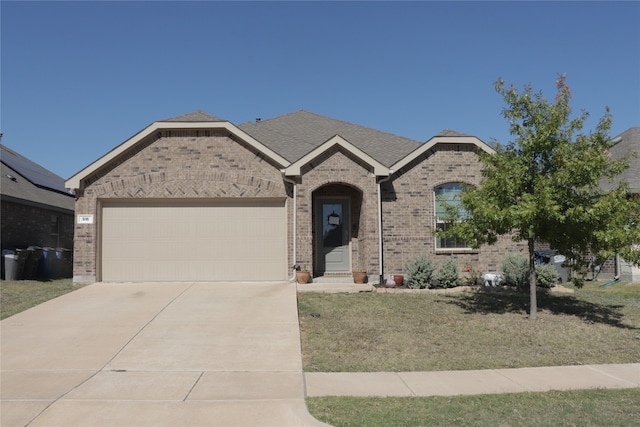 view of front of property with a garage and a front lawn