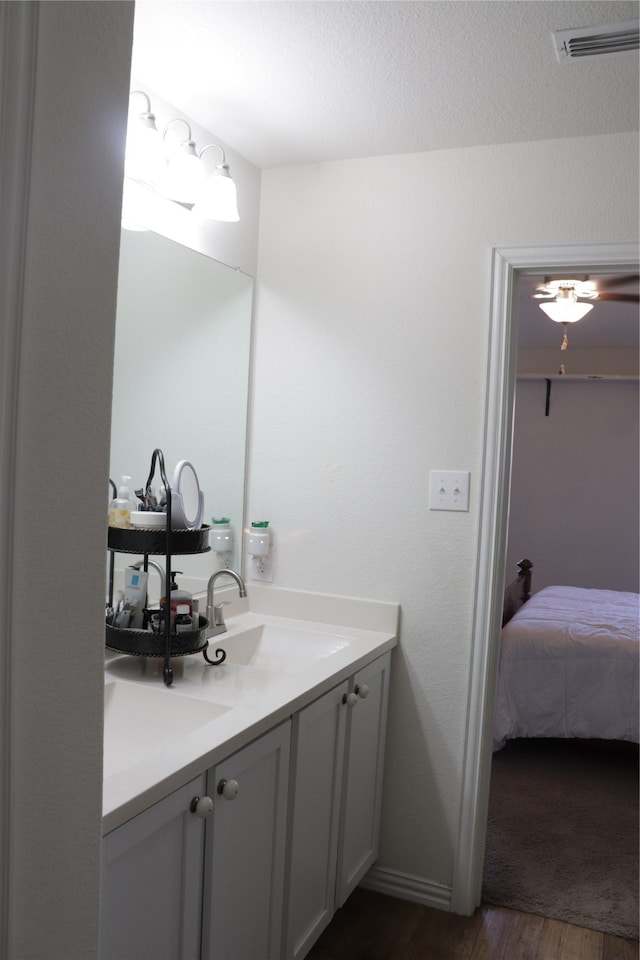 bathroom featuring vanity, hardwood / wood-style flooring, and a textured ceiling