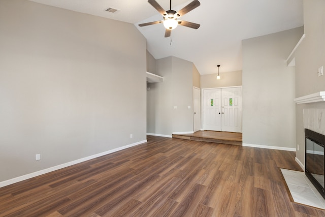 unfurnished living room featuring dark wood-type flooring, ceiling fan, high vaulted ceiling, and a fireplace