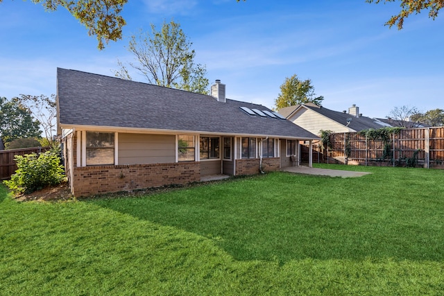 back of house featuring a patio area and a yard