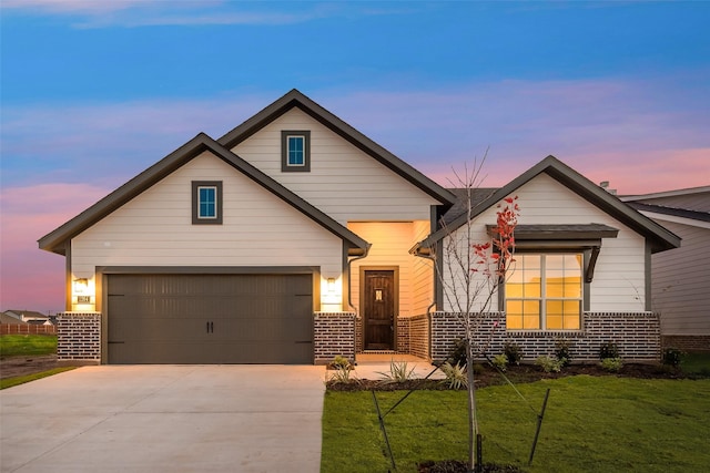 view of front of home with a yard and a garage