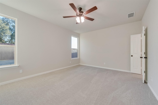 carpeted empty room featuring ceiling fan