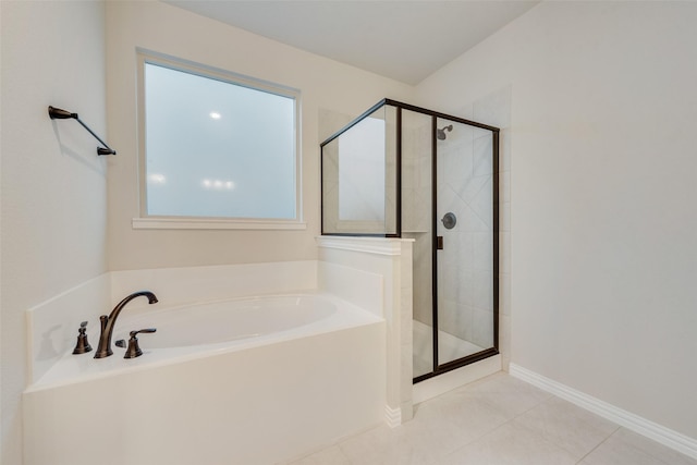 bathroom featuring tile patterned floors and separate shower and tub