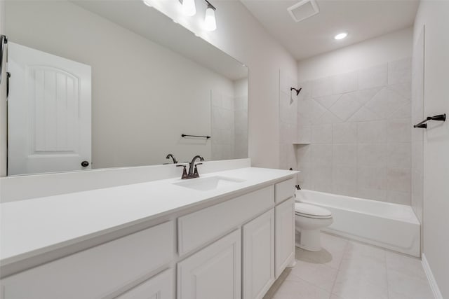 full bathroom with tile patterned flooring, tiled shower / bath combo, toilet, and vanity