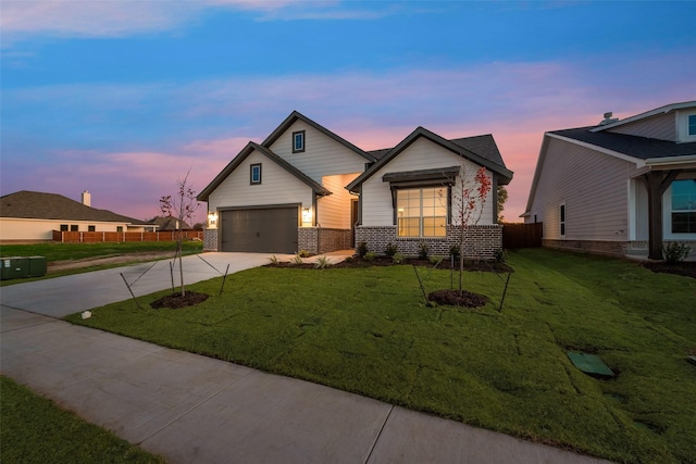 craftsman inspired home featuring a garage and a yard